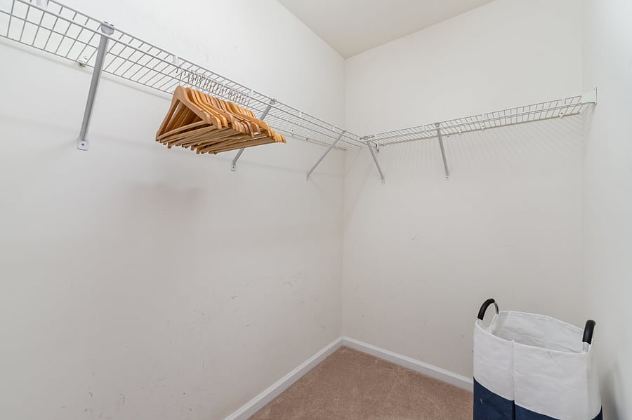 Walk-in closet offers ample storage space, and includes laundry basket