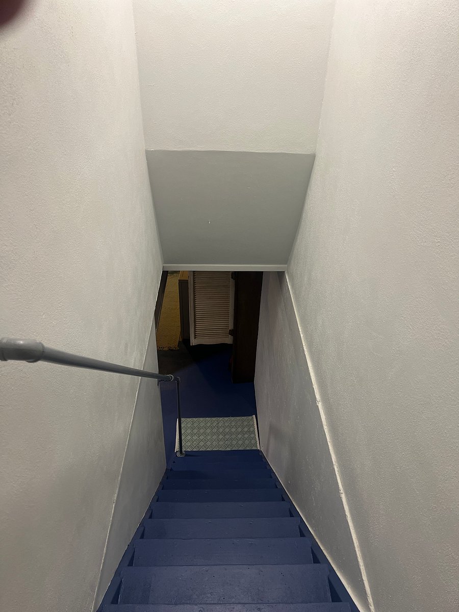 Stairwell to basement at garage entrance 