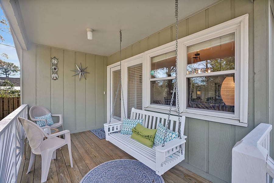 Front porch has swing and chairs to enjoy.