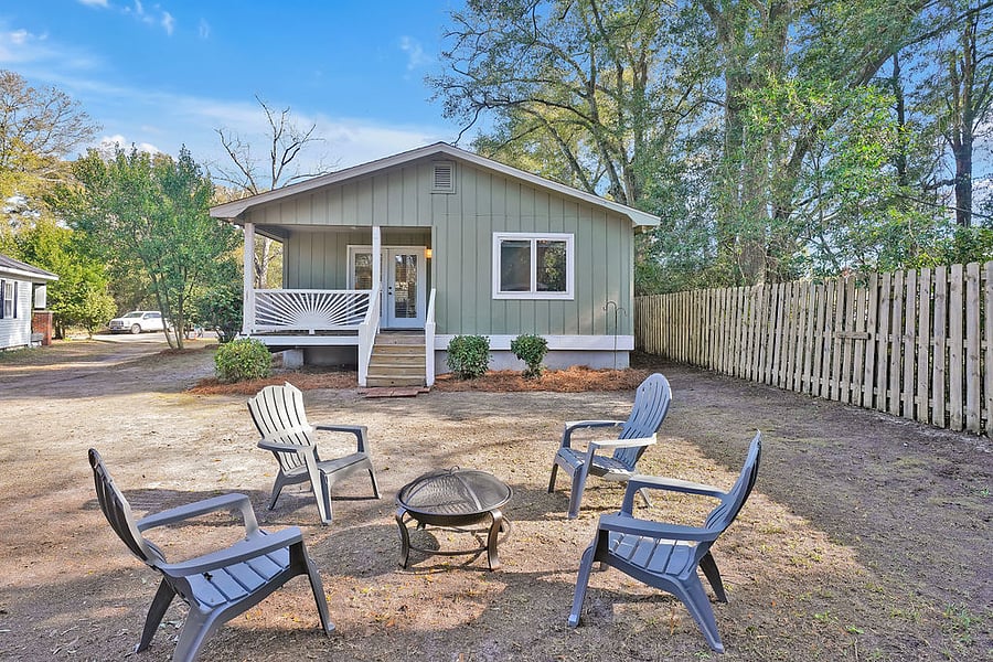 Firepit and chairs in backyard.