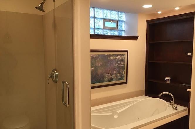 The basement is fully renovated and this is the basement bathroom. A jacuzzi tub, and full shower. We have also added a TV above the tub.