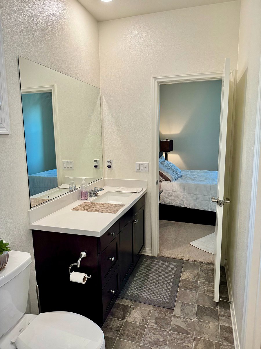 Entire private bathroom/ensuite with sliding glass door shower and walk in closet.