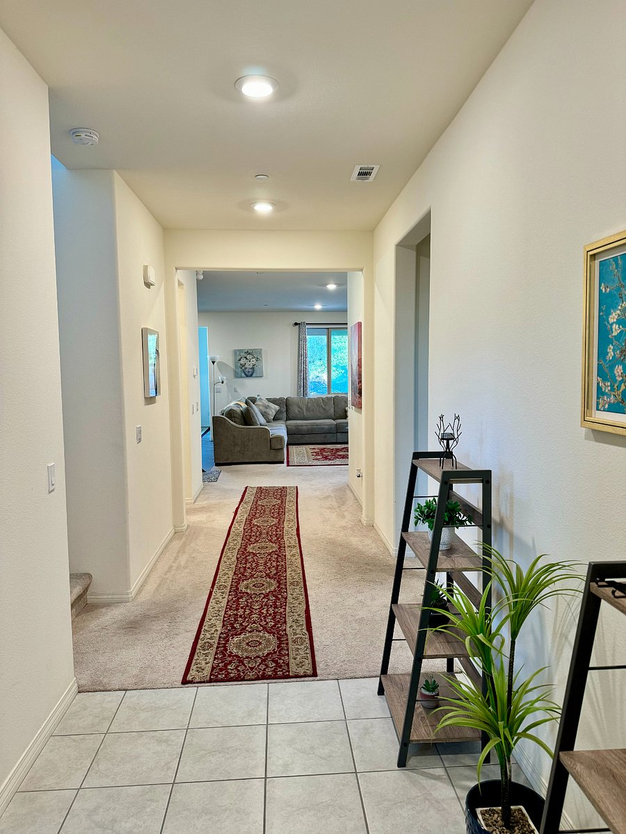 Entry hallway that leads into room on right and common spaces straight ahead.