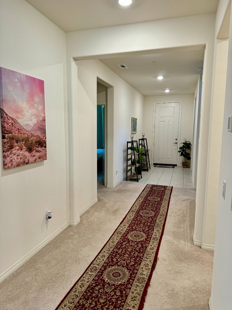 Entry hallway that leads into room on left and common spaces straight ahead.