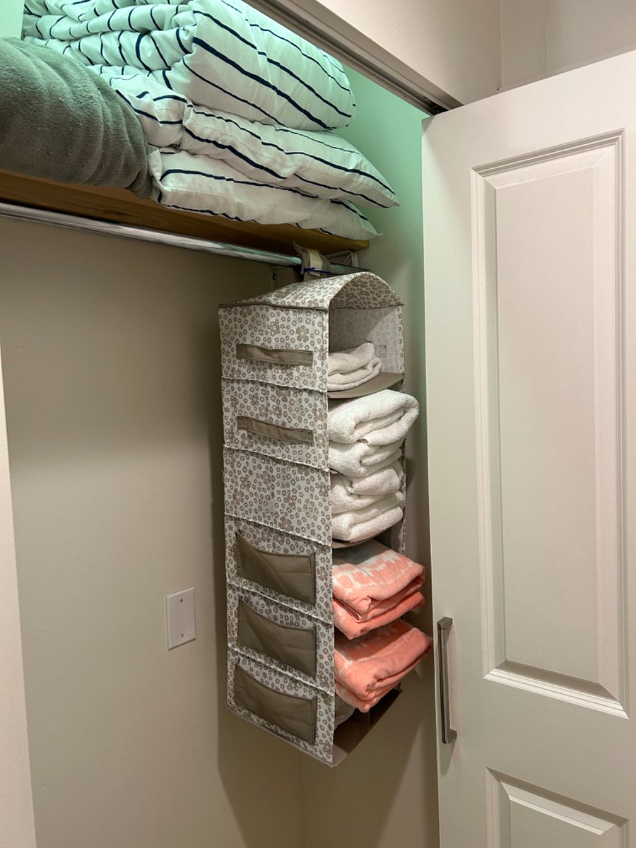second closet in hallway, towels, extra sheets,  Iron, Iron board, extra bedding set for living room sofa bed.