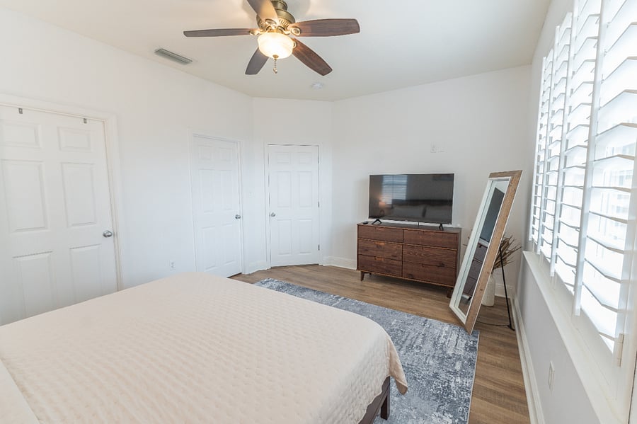 Master bedroom (sleeps 2): King bed, walk-in closet, dresser, smart TV, private full bathroom with essentials and ample storage, ceiling fan