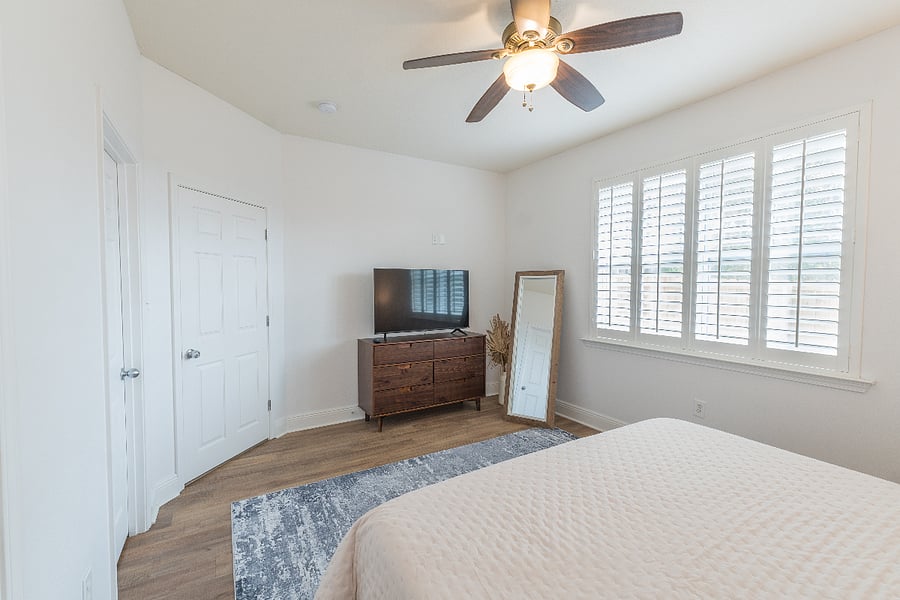 Master bedroom (sleeps 2): King bed, walk-in closet, dresser, smart TV, private full bathroom with essentials and ample storage, ceiling fan