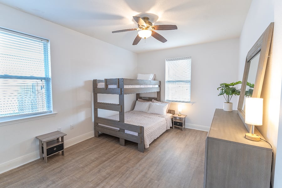Guest room (sleeps 3): Bunk bed (Twin XL over Queen), closet, dresser, ceiling fan