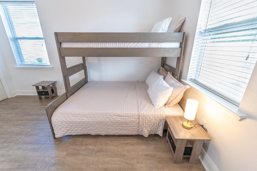 Guest room (sleeps 3): Bunk bed (Twin XL over Queen), closet, dresser, ceiling fan