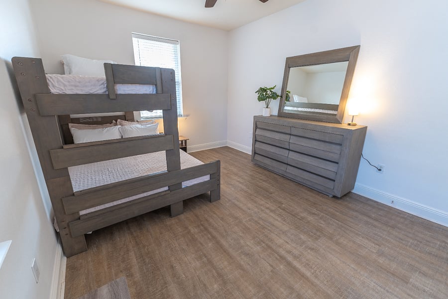 Guest room (sleeps 3): Bunk bed (Twin XL over Queen), closet, dresser, ceiling fan