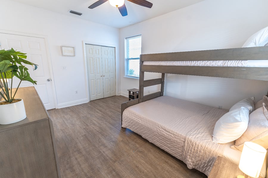 Guest room (sleeps 3): Bunk bed (Twin XL over Queen), closet, dresser, ceiling fan