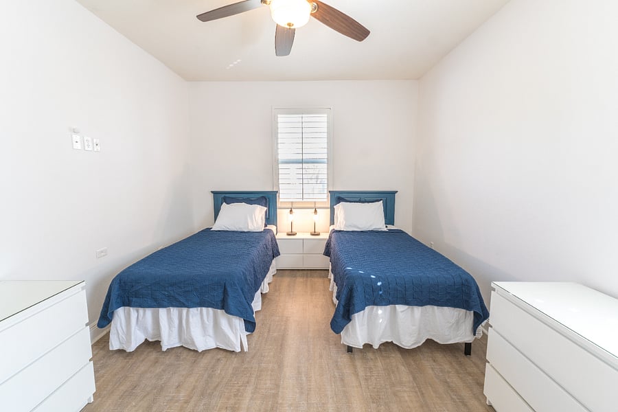 Guest room (sleeps 2): 2 Twin XL beds, closet, dressers, ceiling fan