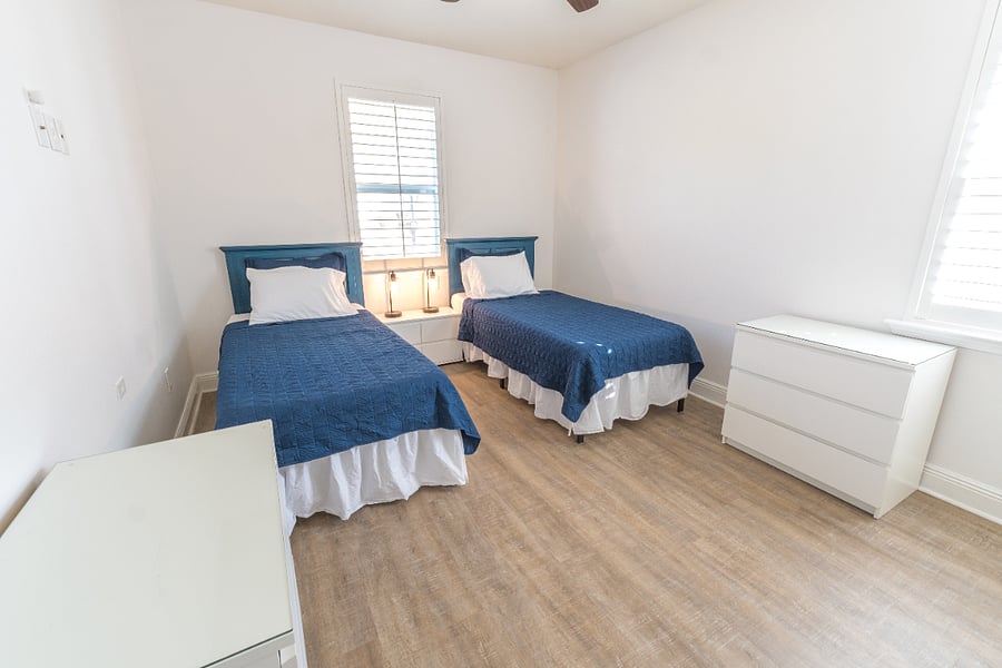 Guest room (sleeps 2): 2 Twin XL beds, closet, dressers, ceiling fan