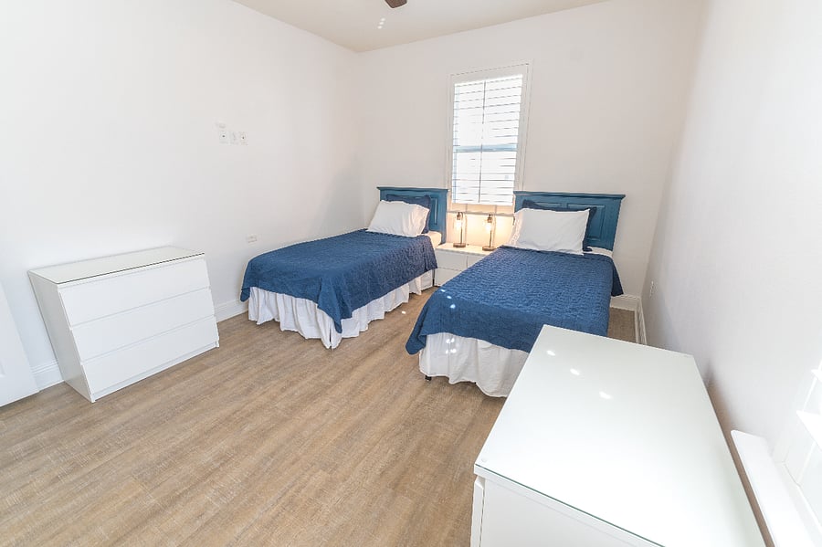 Guest room (sleeps 2): 2 Twin XL beds, closet, dressers, ceiling fan