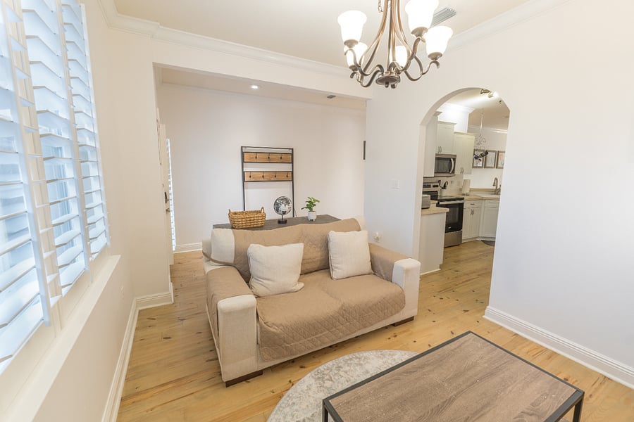 Living room: Smart TV, plush couch, board games