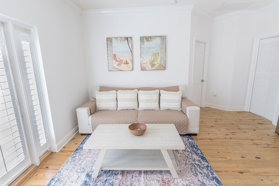 Dining area: 6 person dining table, 4 person bar, plush couch, ceiling fan