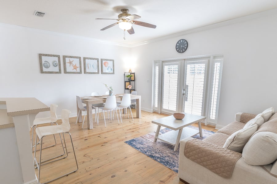 Dining area: 6 person dining table, 4 person bar, plush couch, ceiling fan