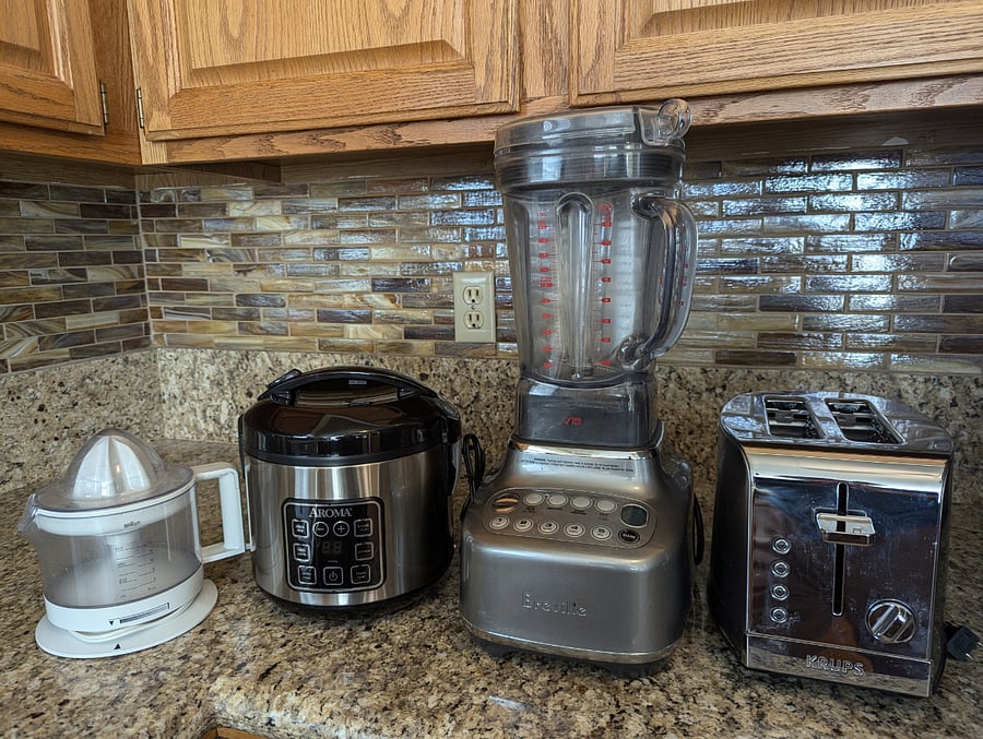 Full range of small appliances including large slice toaster, Breville blender, citrus juicer and rice maker.