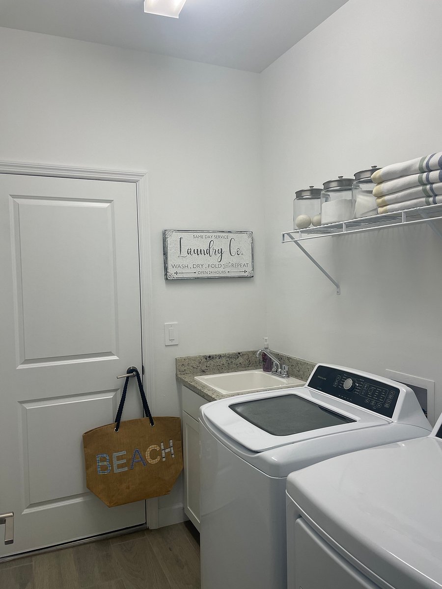 Laundry room leading to 3 car garage