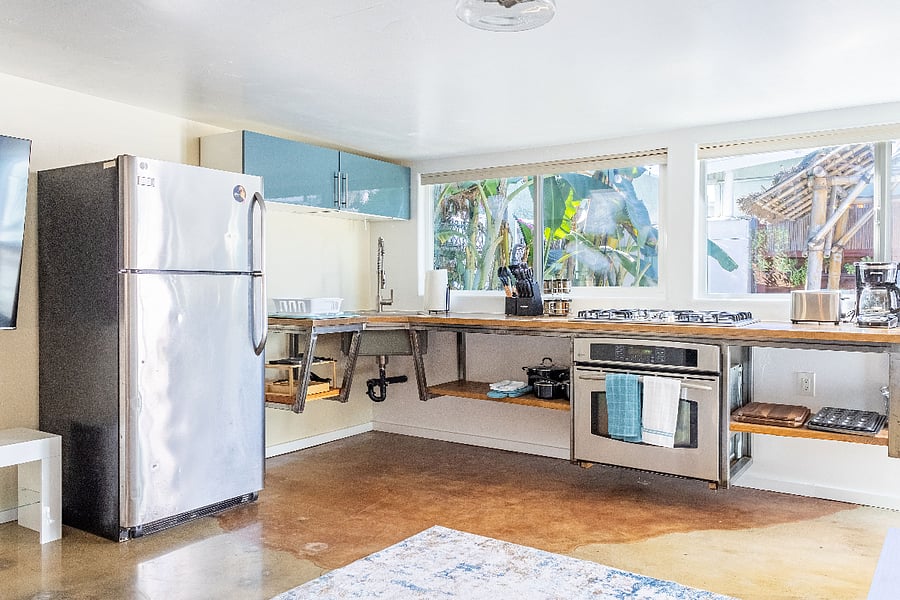 kitchen windows look out to tropical enclosed patio