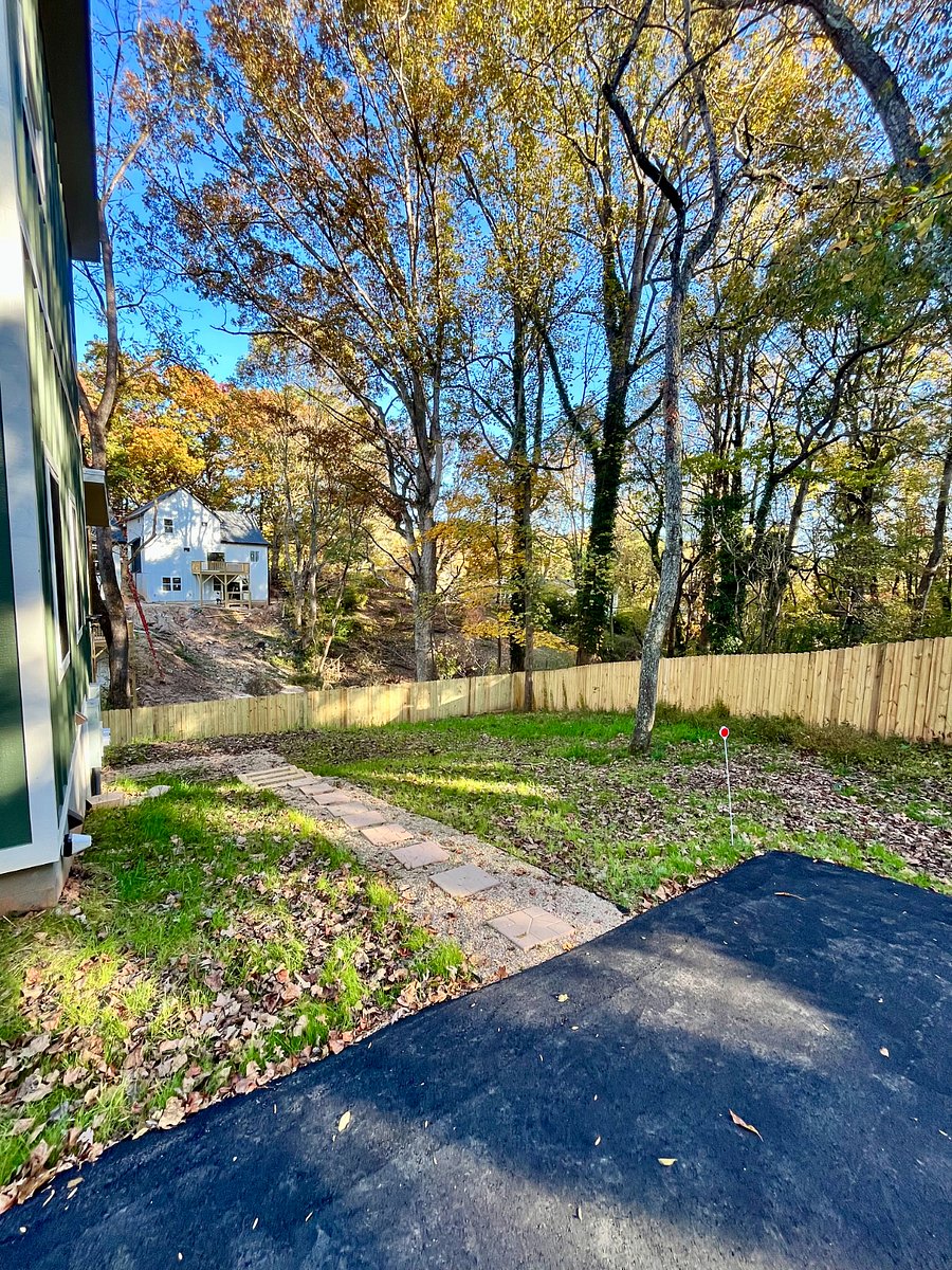 Walkway to studio apartment with fenced in backyard