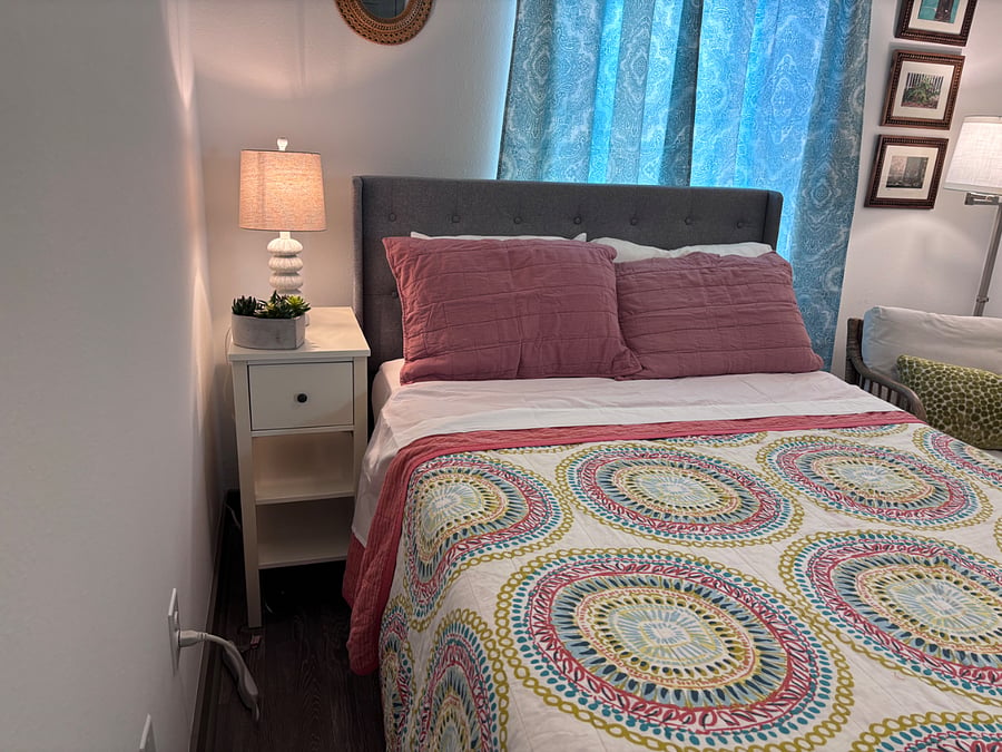 Lamp and side table, with drawers and shelving.