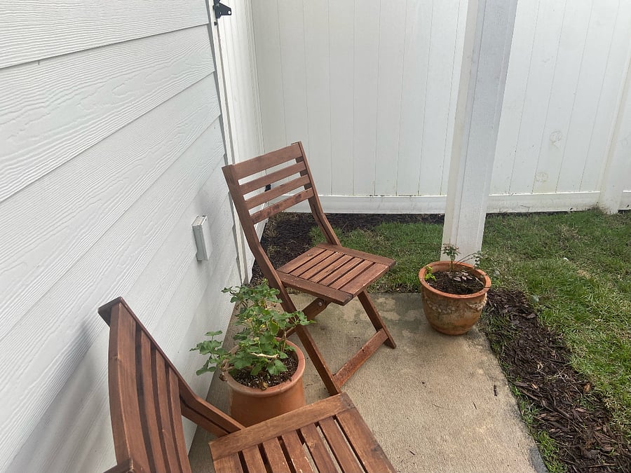 Covered back porch seating area.