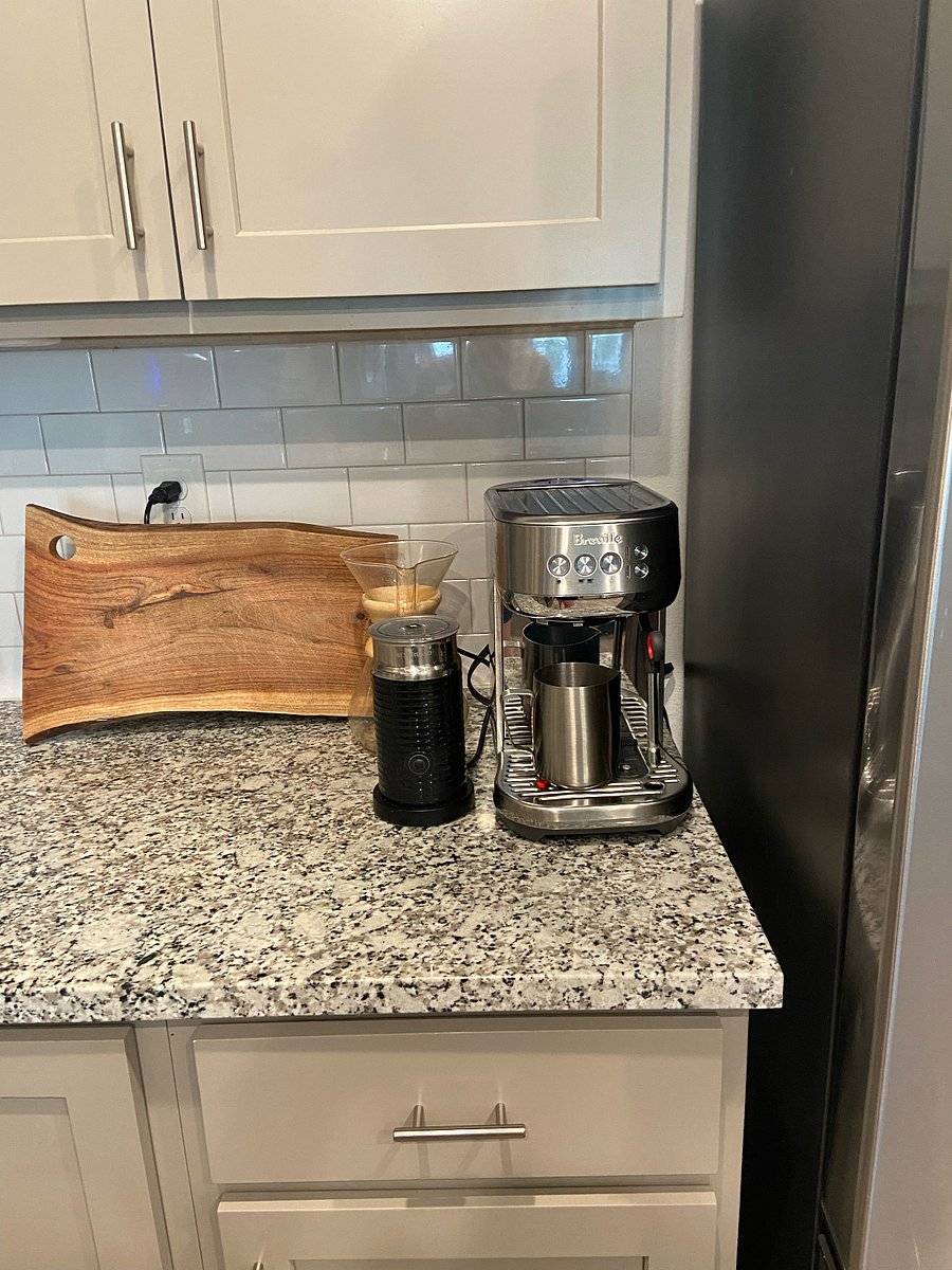 Breville espresso machine, Nespresso milk frother, and pour over coffee maker.