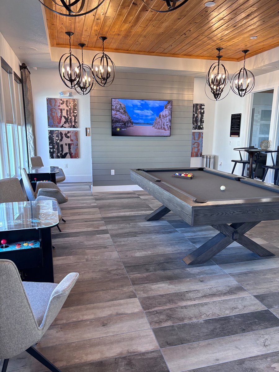 Game room including arcade games, billiards table, and tv.