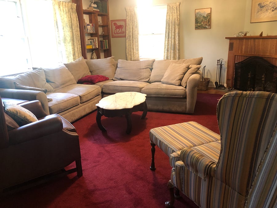 Large living room with super comfortable furniture and a wall mounted smart TV.