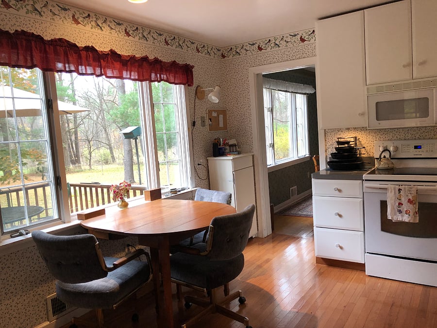 Bright, eat-in kitchen with view of back yard and desk.