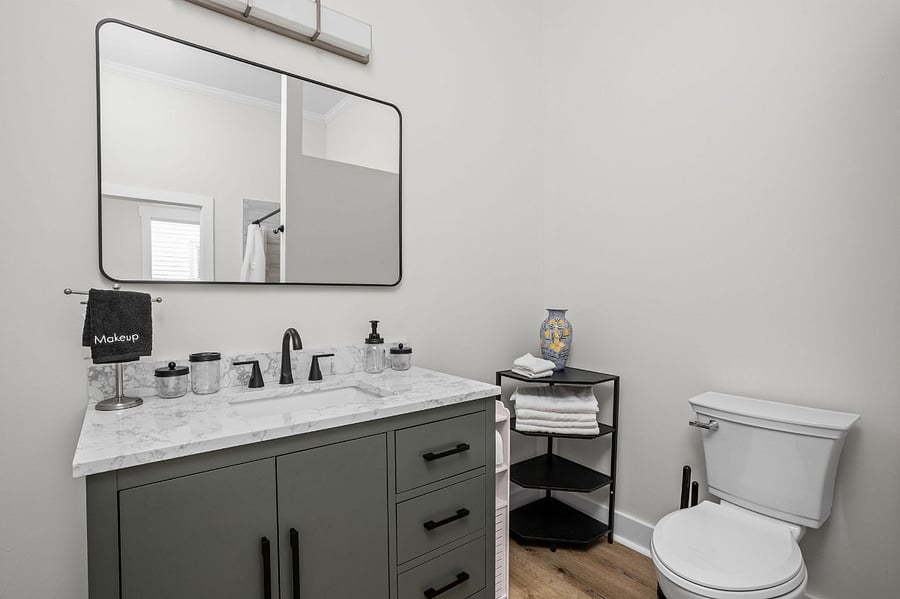 Modern bathroom with a sleek vanity, marble countertop, and minimalist decor.