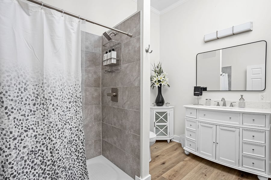 Elegant bathroom with a modern shower and stylish vanity.