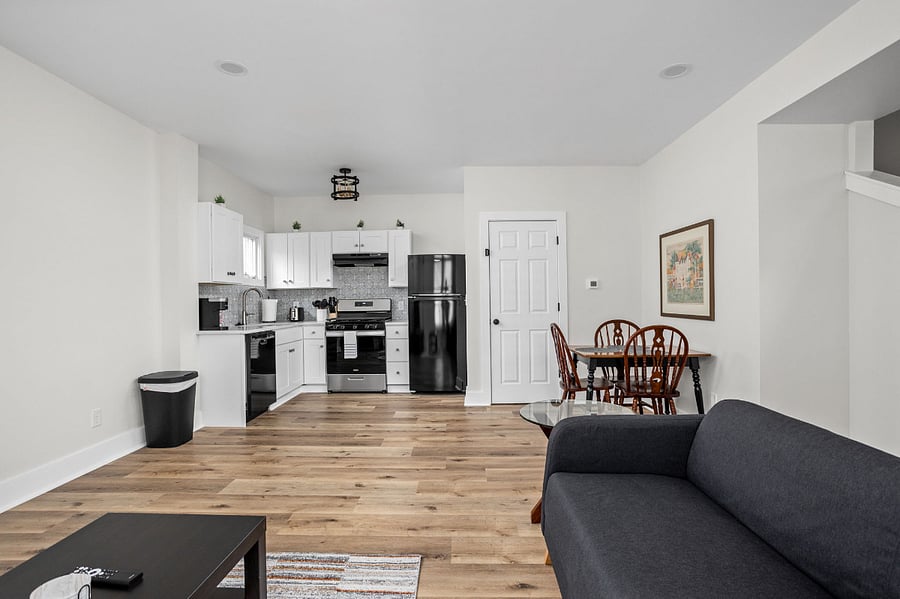 Modern open-concept living space featuring a stylish kitchen, dining area, and cozy seating with a contemporary touch.