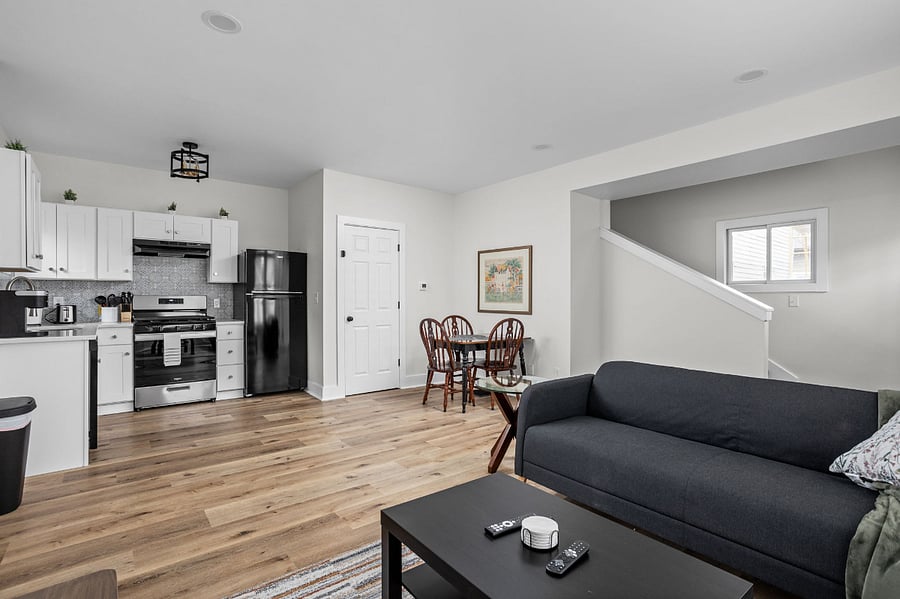 Modern open-concept living space with a sleek kitchen, cozy seating area, and stylish dining nook.