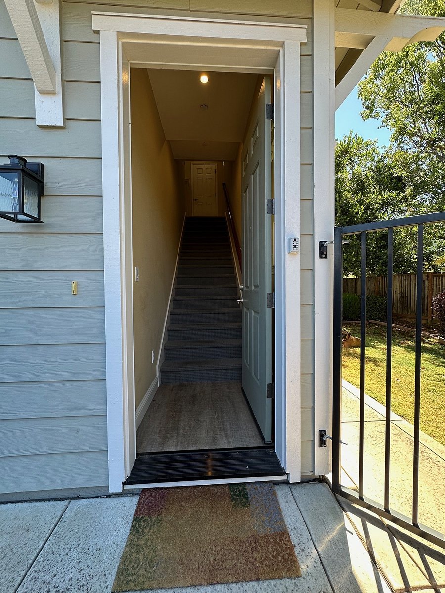 Apartment is above the garage, with interior stairs going up to kitchen and living area