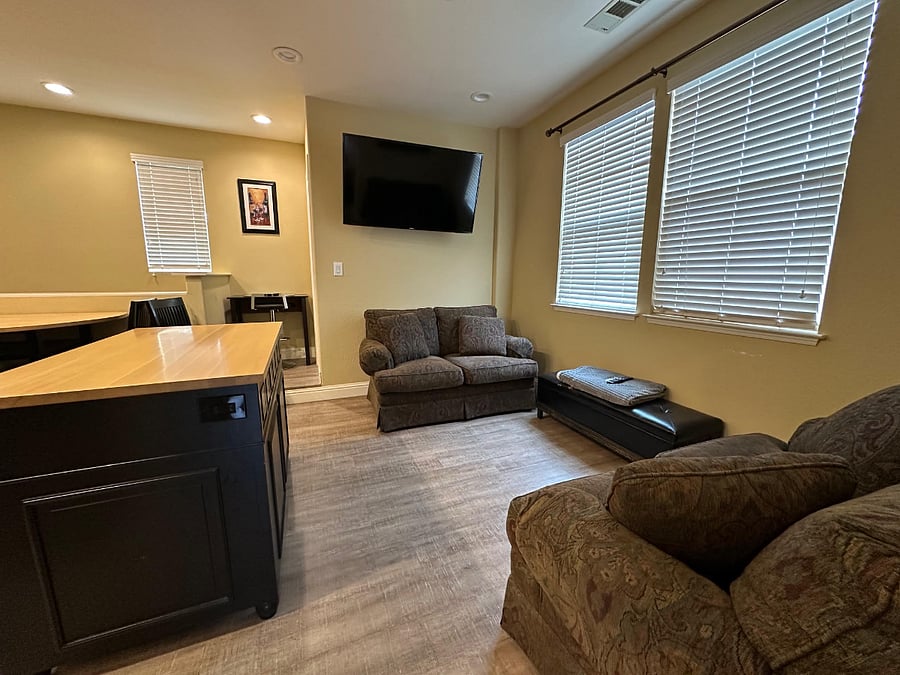 moveable island and living room area looking toward the half bath, smartTV with AppleTV and use of many streaming apps and digital antenna for local channels (no cable)