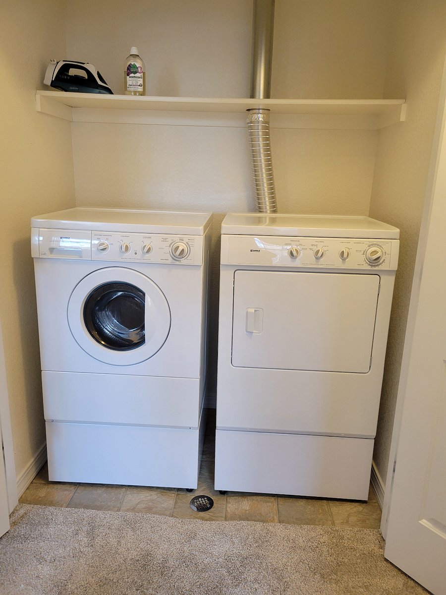 Washer and dryer in hall, with iron/ironing board provided
