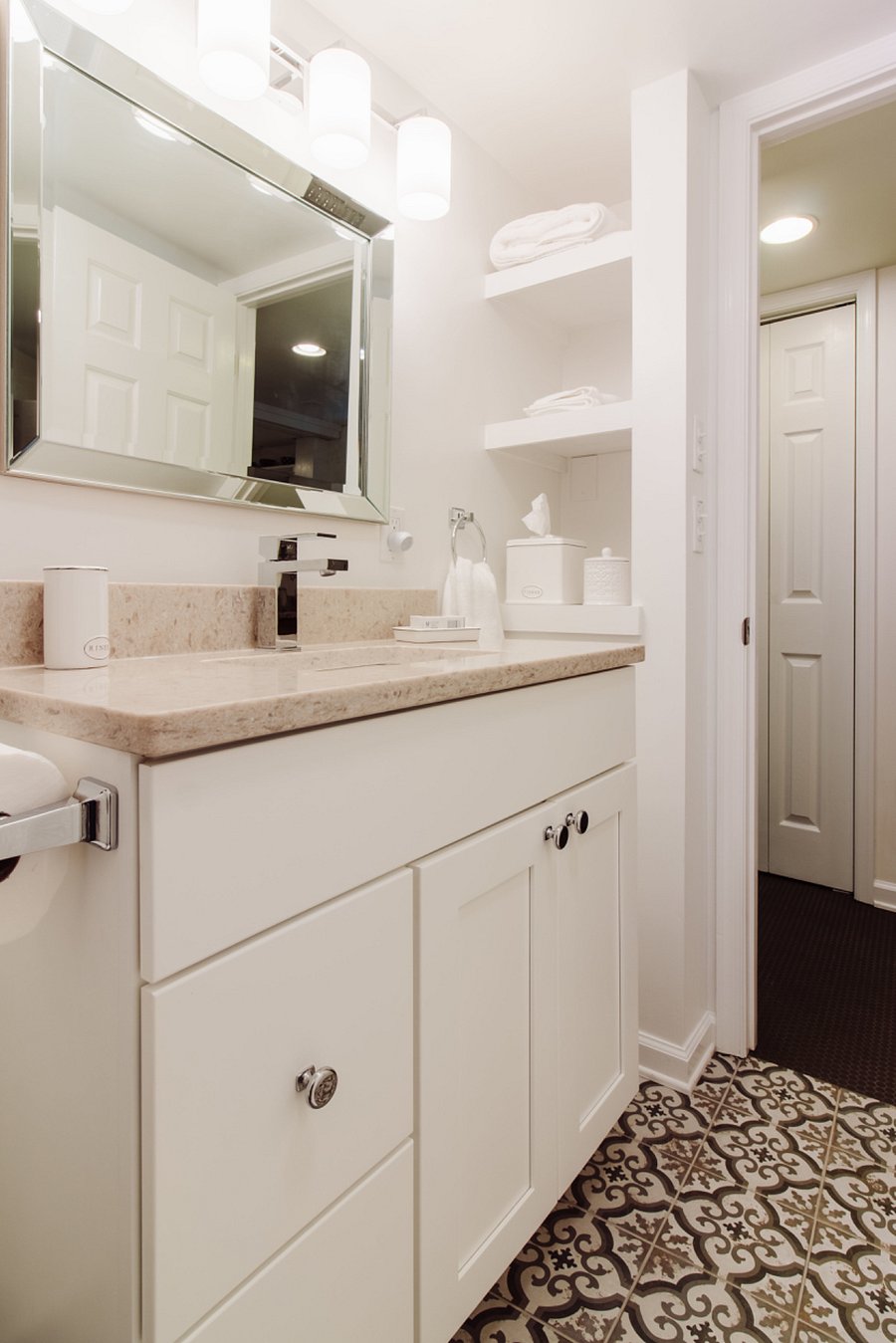 Bathroom w/storage shelves.