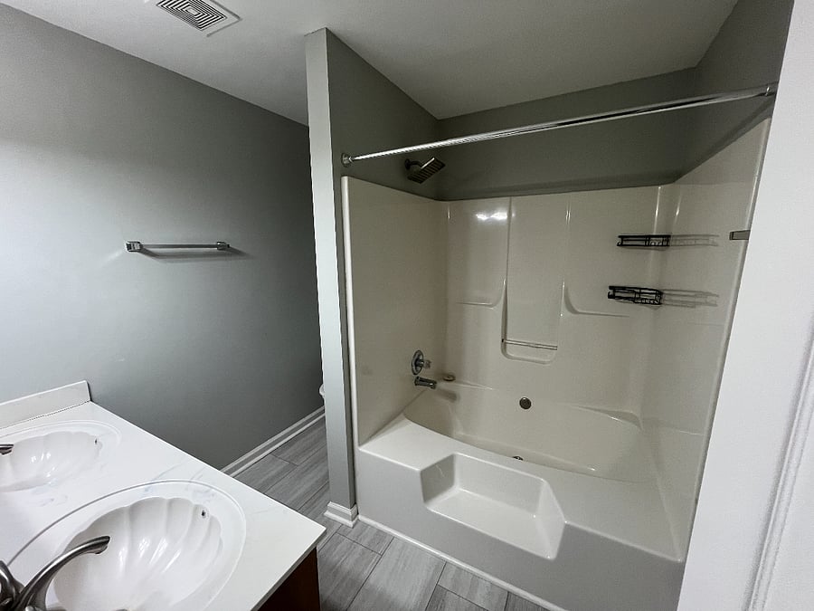 Primary bathroom with double vanity and jacuzzi tub