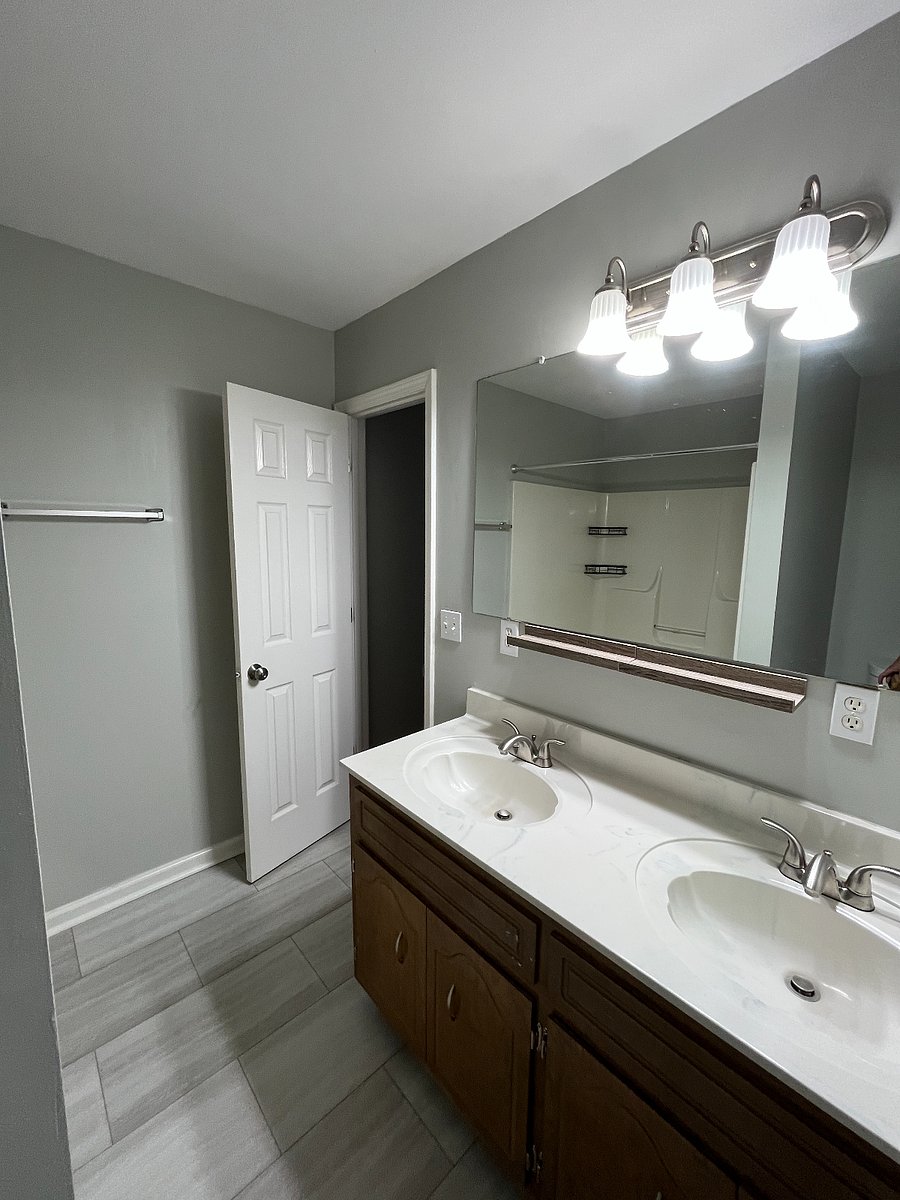 Primary bathroom with double vanity and jacuzzi tub