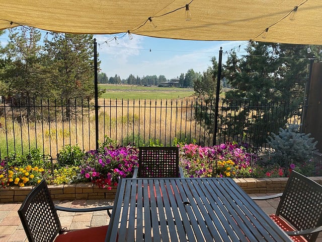 Private patio with dining set and BBQ.