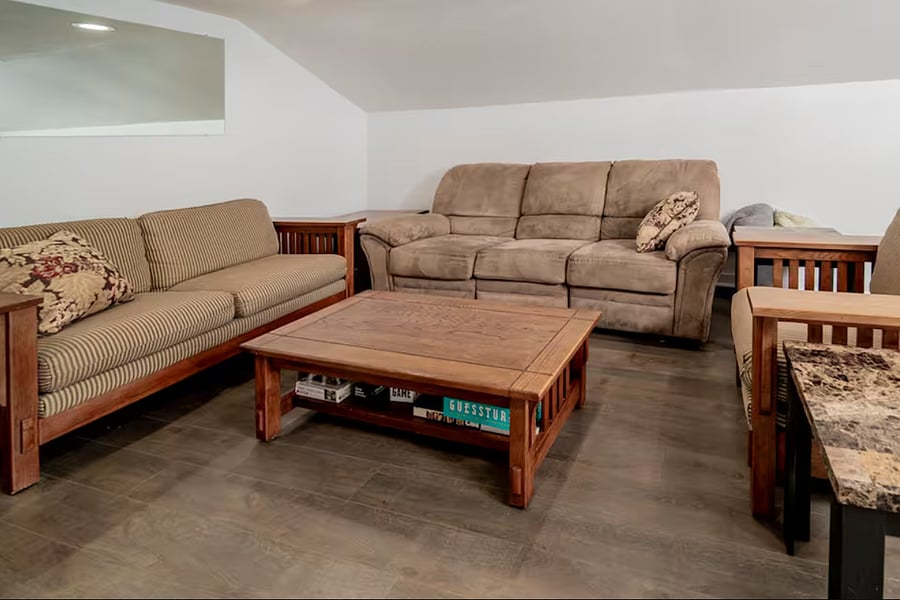 Plenty of seating space in the living room, complete with a Roku TV and games.