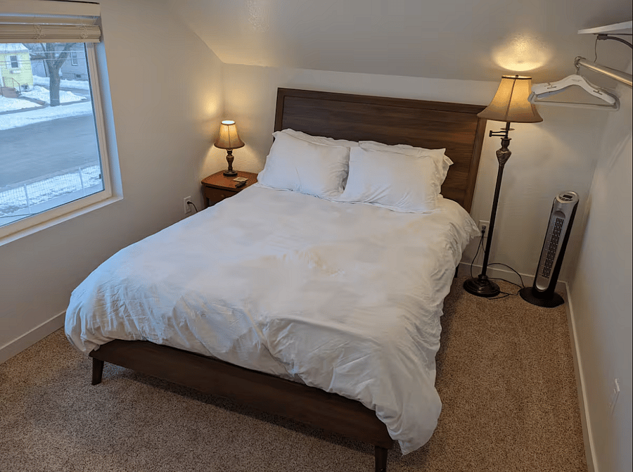 2nd bedroom is equipped with an office desk and chair, Roku TV and fan.