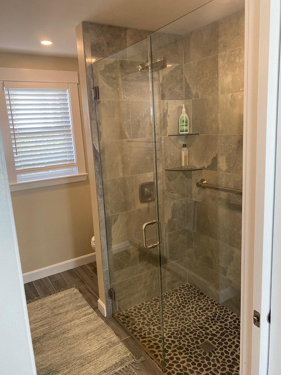 Shower with rainhead, hand held, pebble tile floor.