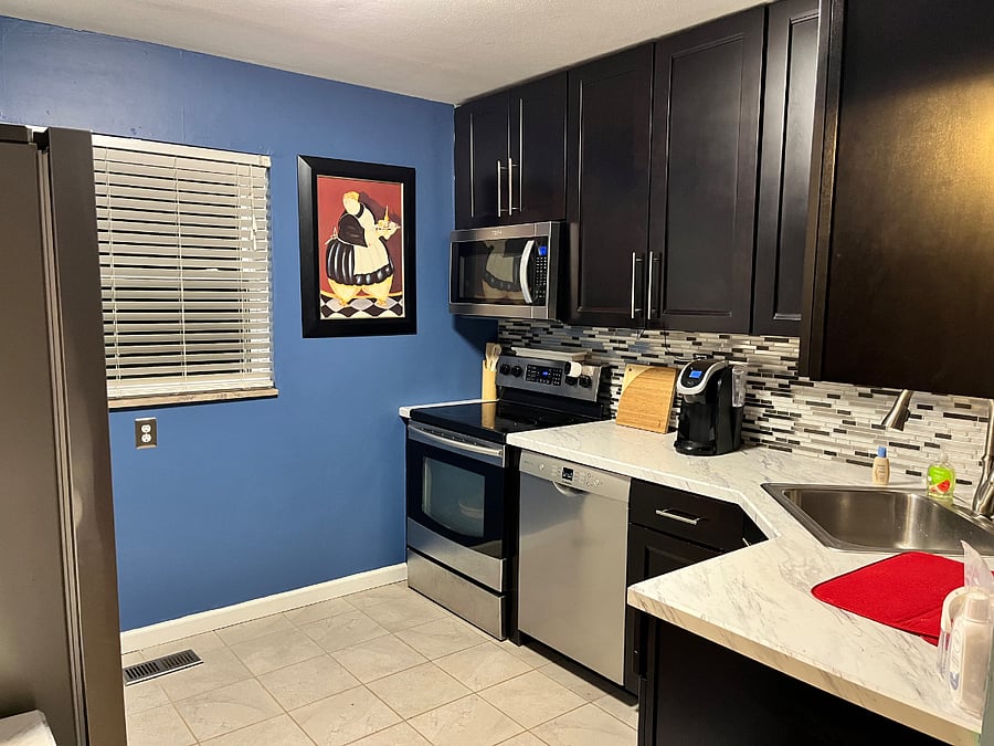 Kitchen with full size refrigerator, stove/oven, microwave and dishwasher