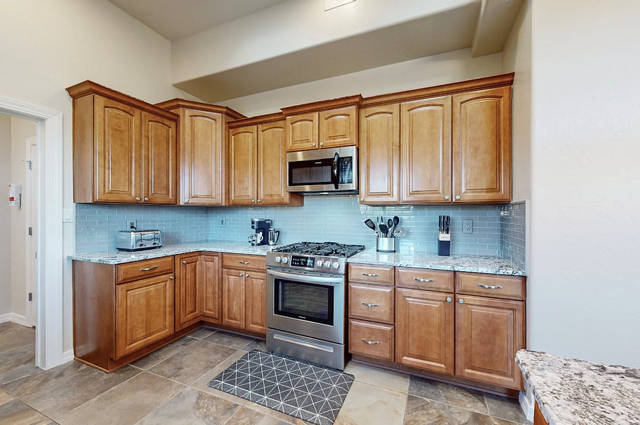 This modern kitchen is fully stocked with both small and large appliances, providing everything you need to prepare breakfast, lunch, dinner, dessert, and all the snacks you desire.