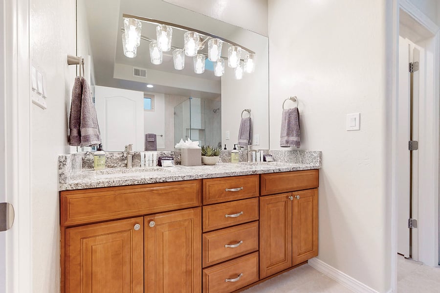 Soak away the day in this elegant bathroom featuring a spacious glass-enclosed shower, a luxurious soaking tub, and modern decor perfect for unwinding after a day of work or family adventures.