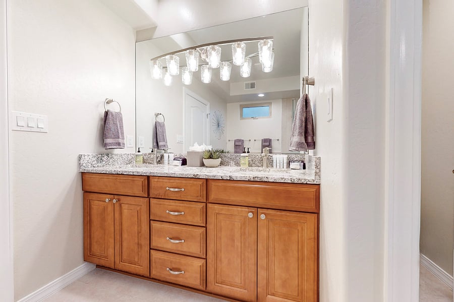 Soak away the day in this elegant bathroom featuring a spacious glass-enclosed shower, a luxurious soaking tub, and modern decor perfect for unwinding after a day of work or family adventures.
