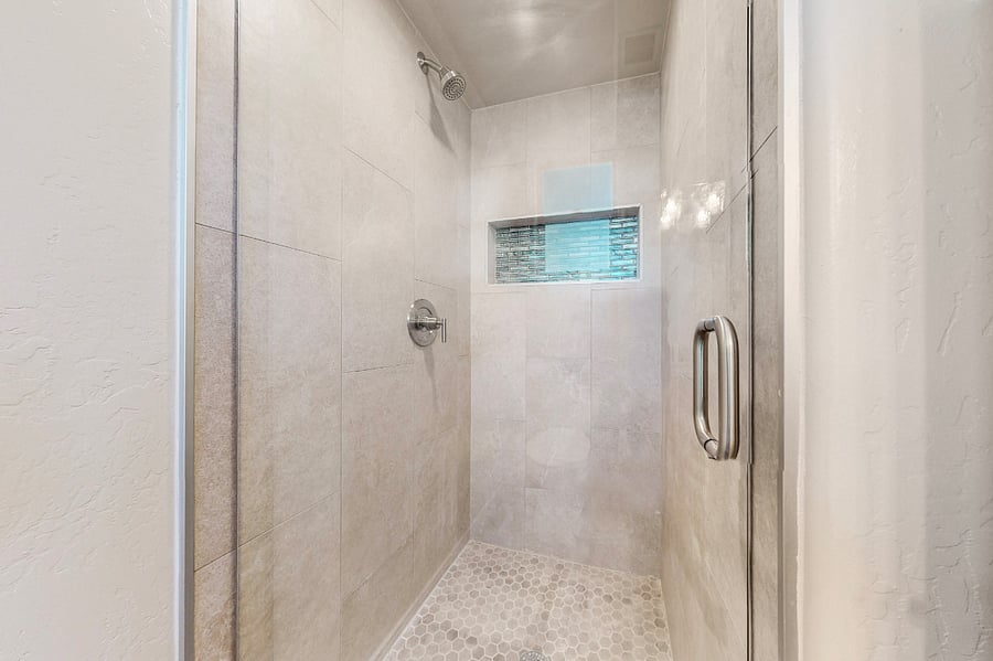 The private secondary ensuite features a full bathroom with a sleek stand-up shower, providing convenience and modern comfort for your stay.